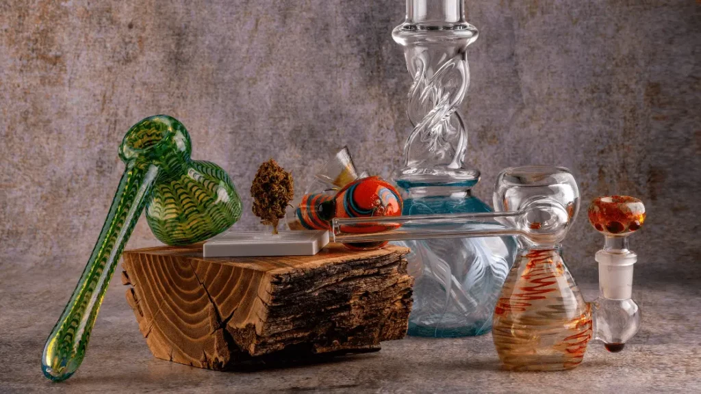 Smoke Gear Shop -Smoke Gear Shop Colorful assortment of bongs water pipes and bubblers placed on a rustic wooden surface min 1024x576 1
